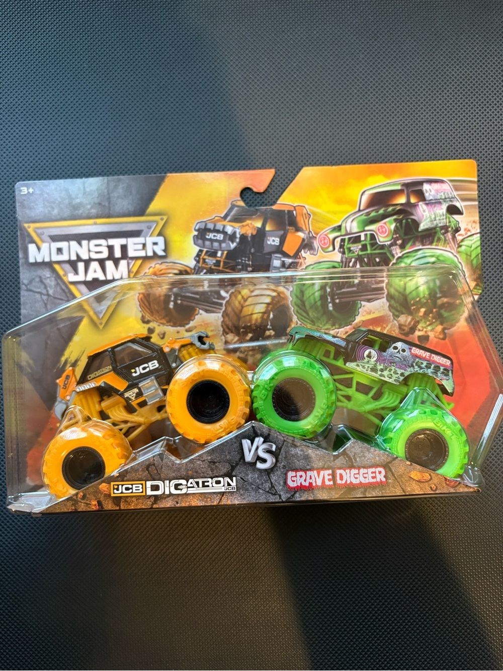 JCB Digatron vs Grave Digger Toy Truck Set - Orange & Green